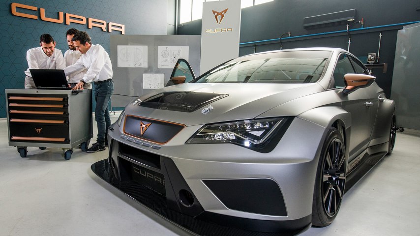 CUPRA car in with employees looking computer