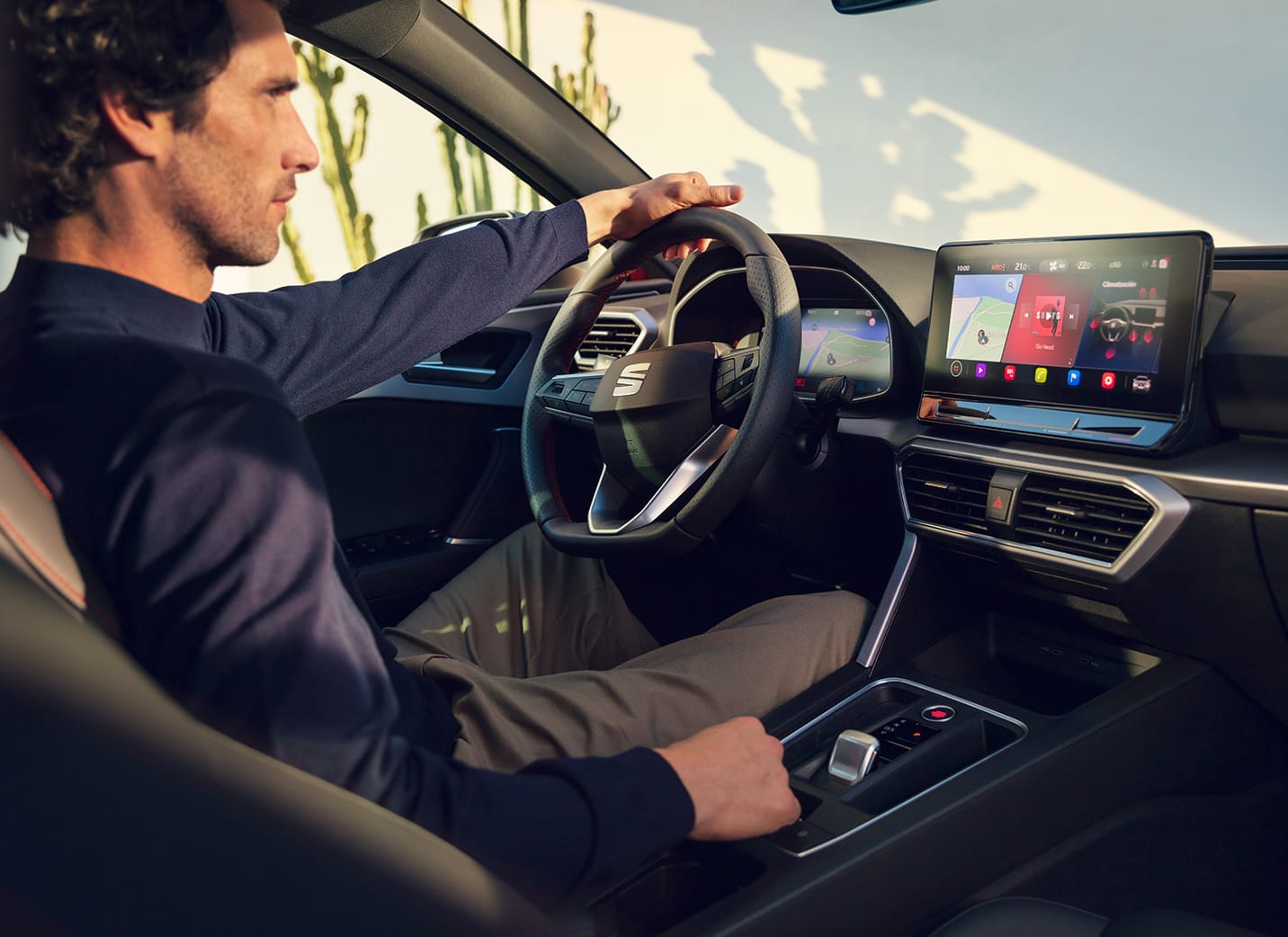 A person holding a smartphone using the my seat app, a feature of seat connect, for remote access and vehicles features.